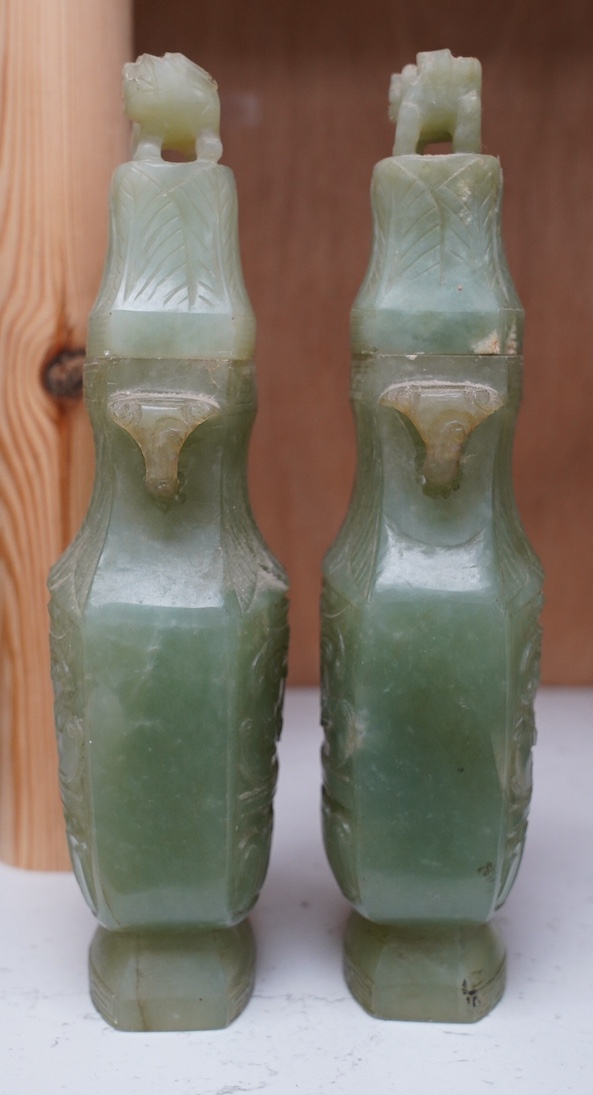 A pair of Chinese carved green quartz vases and covers, 21cm. Condition - fair, natural crack to body of one vase, chips to edges of both